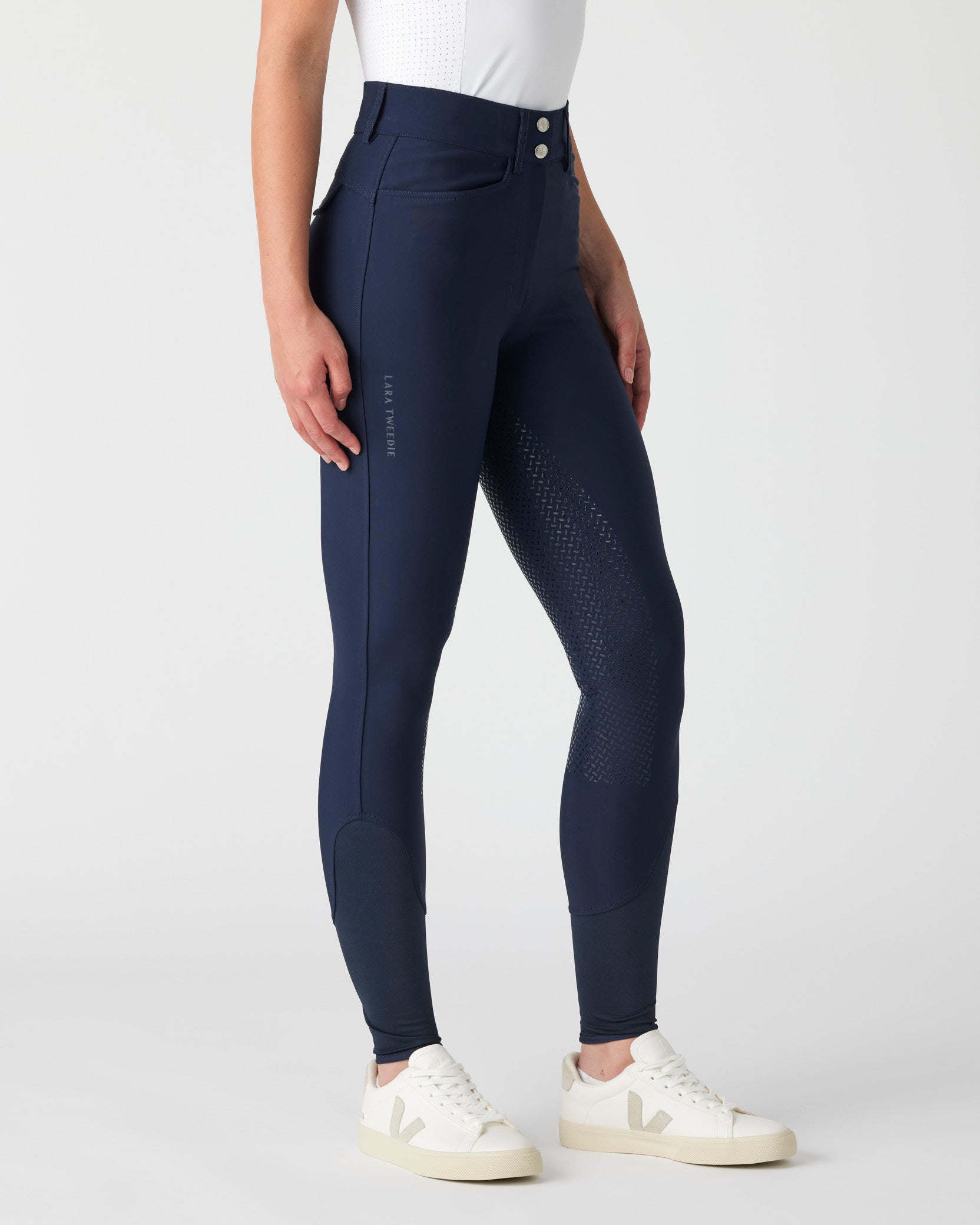 Navy riding pants worn by a woman 
